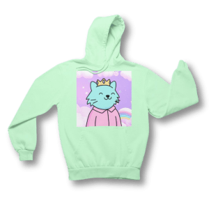 Mint green hoodie with a graphic print of a regal cat character crowned and smiling, set against a soft pastel background with clouds and rainbows